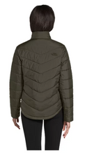 Load image into Gallery viewer, Woman wearing a green North Face quilted jacket. Back view.
