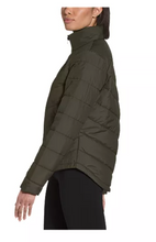 Load image into Gallery viewer, Woman wearing a green North Face quilted jacket. Side view.
