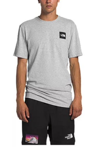 Man wearing a grey t-shirt and black The North Face shorts.