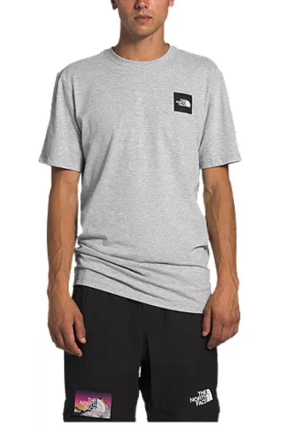 Man wearing a grey t-shirt and black The North Face shorts.